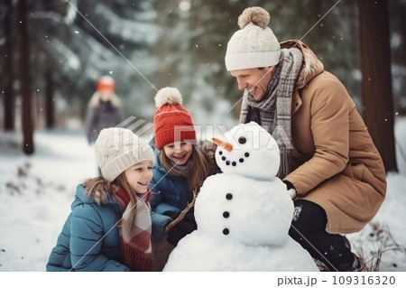 Happy father, mother and kids sculpting funny snowman comeliness 109316320