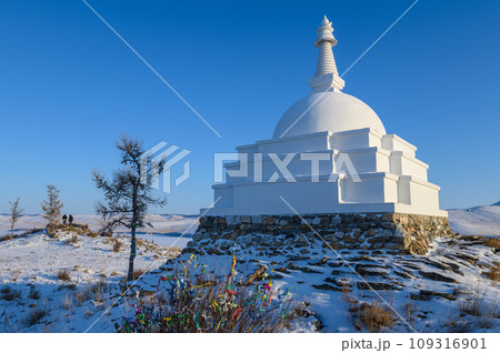 An iconic white Buddhist stupa on small sacred hill in lake Baikal, Russia. An iconic white Buddhist stupa on small sacred hill in lake Baikal, Russia. 109316901