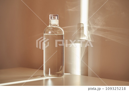 A bottle of clean drinking water in a ray of morning sun. 109325218