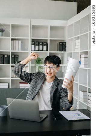 Asian business man are delighted and happy with the work they do on their tablet, laptop and taking notes at the office.. Asian business man are delighted and happy with the work they do on their tablet, laptop and taking notes at the office.. 109325398