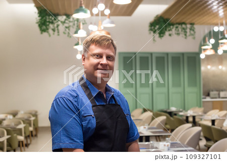 Portrait of a male waiter, blond, 40-44 years old, close-up Portrait of a male waiter, blond, 40-44 years old, close-up 109327101
