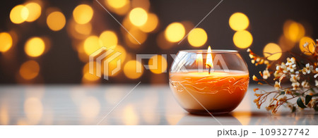 Banner with a burning aromatic candle on a background of New Year's garlands, holiday invitation or postcard and flyer for advertising Banner with a burning aromatic candle on a background of New Year's garlands, holiday invitation or postcard and flyer for advertising 109327742