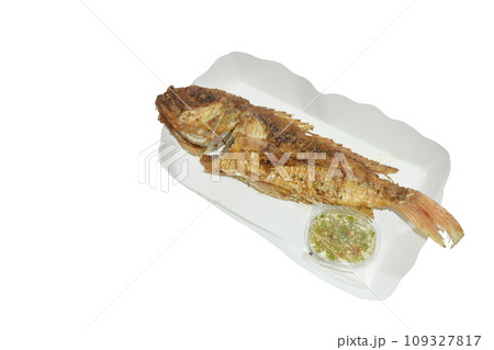 crispy fried fresh red snapper fish arranging on paper package dipping spicy chili sauce in white background 109327817