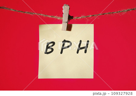 BPH Benign Prostatic Hyperplasia text on a yellow sticker hanging on a rope with clothespins on a red background BPH Benign Prostatic Hyperplasia text on a yellow sticker hanging on a rope with clothespins on a red background 109327928