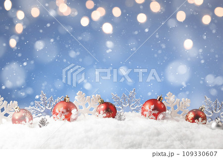 Christmas balls and snowflake with snow on color background Christmas balls and snowflake with snow on color background 109330607