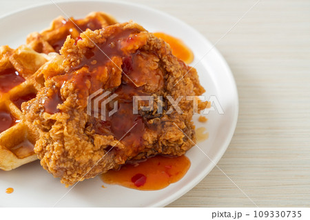 fried chicken with waffle and spicy sauce 109330735