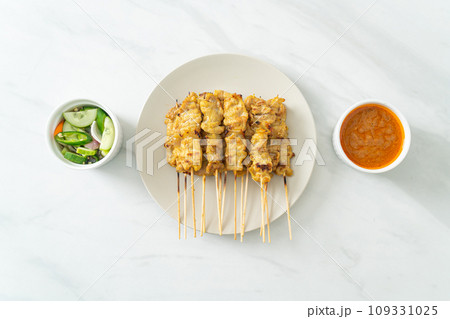 Pork satay with peanut sauce pickles which are cucumber slices and onions in vinegar Pork satay with peanut sauce pickles which are cucumber slices and onions in vinegar 109331025