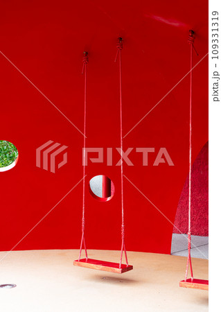 red swing with red background 109331319