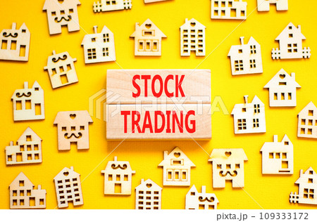 Stock trading symbol. Concept words Stock trading on beautiful wooden blocks. Beautiful yellow table yellow background. House model. Business stock trading concept. Copy space. Stock trading symbol. Concept words Stock trading on beautiful wooden blocks. Beautiful yellow table yellow background. House model. Business stock trading concept. Copy space. 109333172