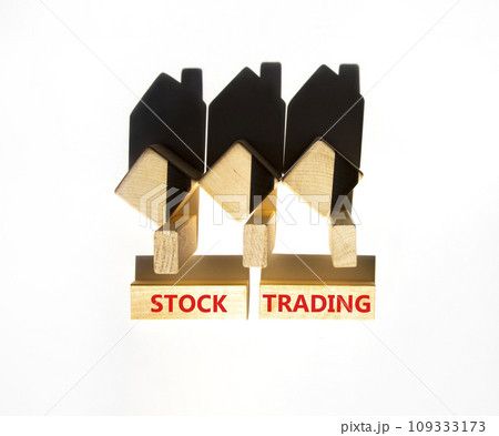 Stock trading symbol. Concept words Stock trading on beautiful wooden blocks. Beautiful white table white background. House model. Business stock trading concept. Copy space. Stock trading symbol. Concept words Stock trading on beautiful wooden blocks. Beautiful white table white background. House model. Business stock trading concept. Copy space. 109333173
