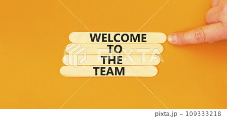Welcome to the team symbol. Concept words Welcome to the team on beautiful wooden stick. Beautiful orange table background. Businessman hand. Business, motivational and welcome to the team concept. Welcome to the team symbol. Concept words Welcome to the team on beautiful wooden stick. Beautiful orange table background. Businessman hand. Business, motivational and welcome to the team concept. 109333218