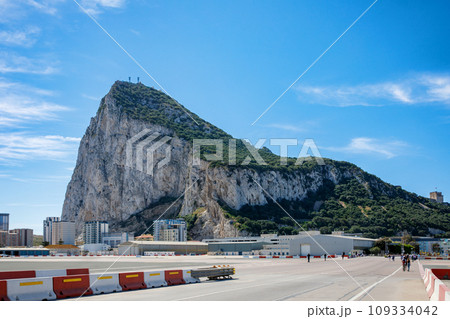 Road to the Rock of Gibraltar with marina on the left and town behind, view from La Linea, Spain Road to the Rock of Gibraltar with marina on the left and town behind, view from La Linea, Spain 109334042