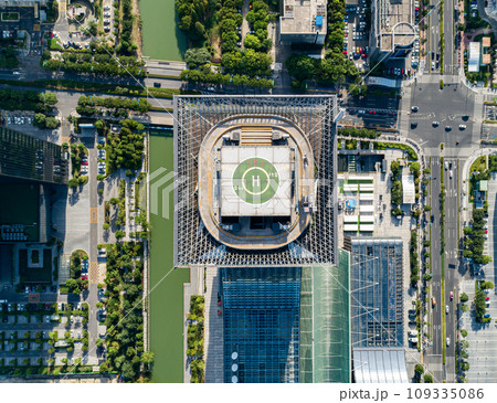 Helipad on the rooftop of the modern skyscraper. Glass business offices district. Aerial drone view of helipad on the roof of a skyscraper in downtown. 109335086