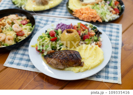 Home made meat dish with salads, in hands dinner time duck and apple 109335416