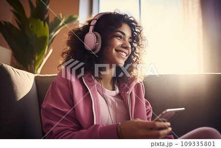 Woman Enjoying Music on a Comfortable Couch 109335801