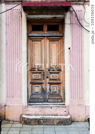 old entrance door of urban apartment building 109336039
