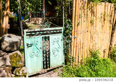 bamboo fence and old gate to rural yard in village 109336218