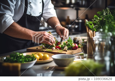 Close up of a professional chef preparing a delicious gourmet dish in a modern kitchen Close up of a professional chef preparing a delicious gourmet dish in a modern kitchen 109336620