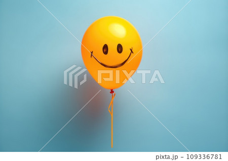 Yellow baloon with a painted smile on background. Holiday. Birthday. 109336781