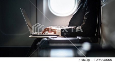 Successful Asian business woman, Business woman working in airplane cabin during flight on laptop computer 109338660