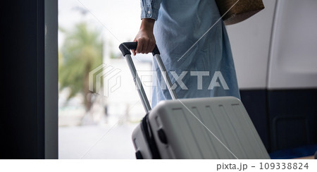 Young woman tourist with a suitcase at the airplane with a suitcase at the airplane 109338824