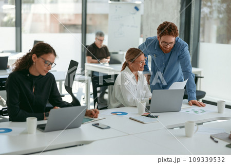 Business people working with laptops in office on colleagues background. Teamwork concept 109339532