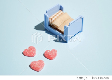 Pattern of gummy vitamin candy in shape of heart on blue background. Concept. Pattern of gummy vitamin candy in shape of heart on blue background. Concept. 109340280