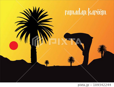 A man silhouettes against a sunset sky as he prays under a palm tree in the desert. 109342244