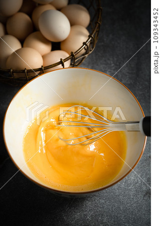Whisk eggs in bowl 109343452
