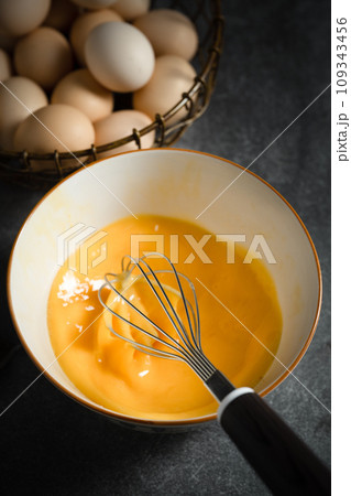 Whisk eggs in bowl Whisk eggs in bowl 109343456