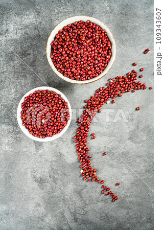 Red adzuki beans on black background plate Red adzuki beans on black background plate 109343607