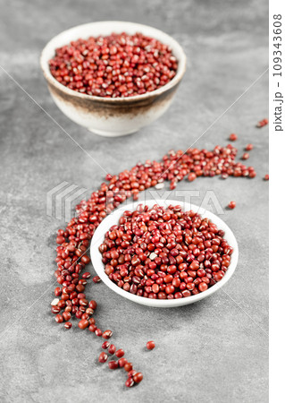Red adzuki beans on black background plate Red adzuki beans on black background plate 109343608