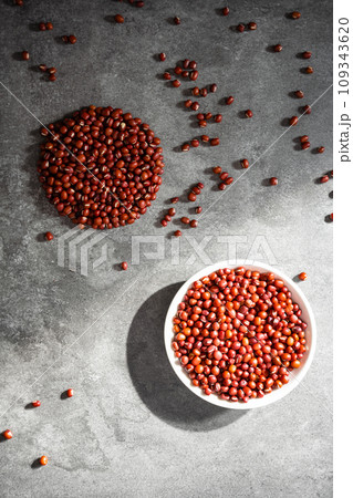 Red adzuki beans on black background plate Red adzuki beans on black background plate 109343620