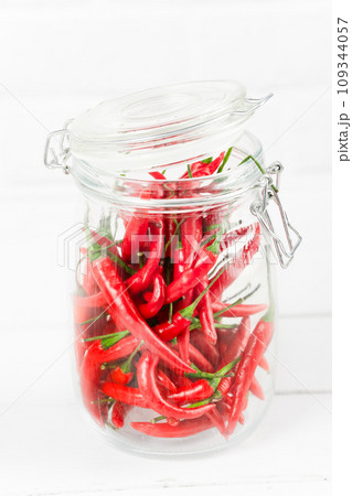 red hot chili peppers in glass jar red hot chili peppers in glass jar 109344057