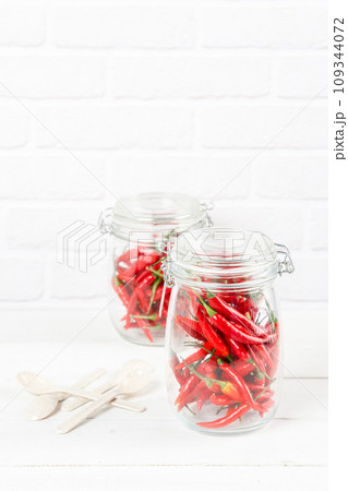 red hot chili peppers in glass jar 109344072