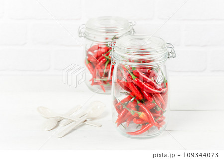 red chili peppers in glass jar 109344073