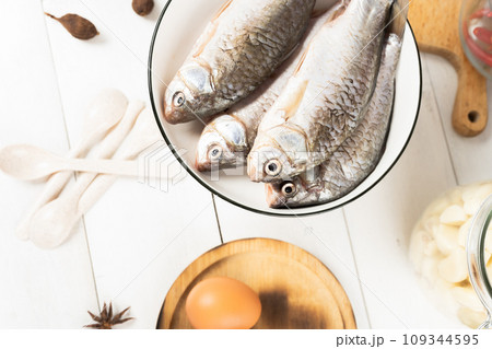fresh fish on a cutting board and knife fresh fish on a cutting board and knife 109344595