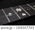 close up shot finger board  pearl inlay , heart and flower , acoustic guitar, selective focus 109347703