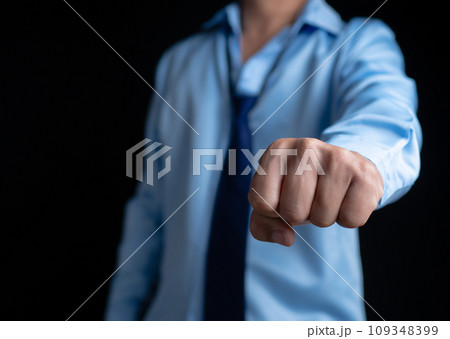 Businessman shows his fists in a fighting stance showing determination. Ready to fight against business competitors. Businessman shows his fists in a fighting stance showing determination. Ready to fight against business competitors. 109348399