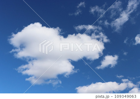 Light gray clouds against a blue sky. 109349063