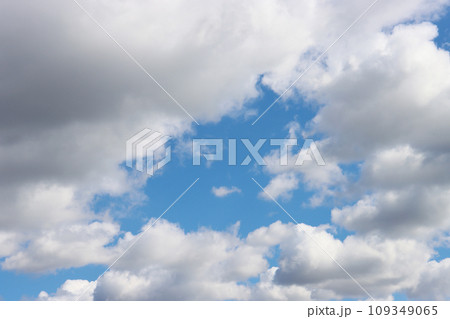 Light gray clouds against a blue sky. 109349065