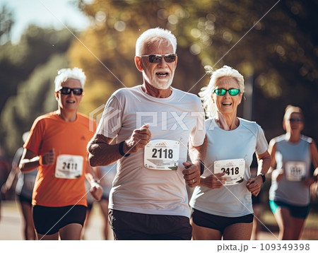 Senior grey haired men and women running a marathon race in a multi generation group of people in the park 109349398