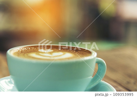 Latte art coffee cup with milk on wooden table. Espresso shot make latte art hot coffee cup. Cappuccino with milk in italian coffee shop cafe. Brown hot caffeine beverage in cafeteria with copy space Latte art coffee cup with milk on wooden table. Espresso shot make latte art hot coffee cup. Cappuccino with milk in italian coffee shop cafe. Brown hot caffeine beverage in cafeteria with copy space 109353995