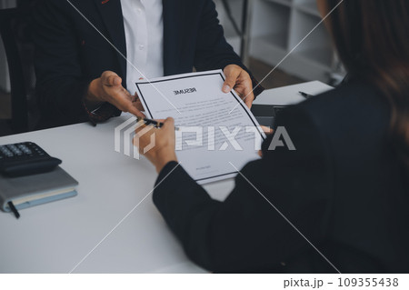 Close up view of job interview in office, focus on resume writing tips, employer reviewing good cv of prepared skilled applicant, recruiter considering application, hr manager making hiring decision Close up view of job interview in office, focus on resume writing tips, employer reviewing good cv of prepared skilled applicant, recruiter considering application, hr manager making hiring decision 109355438