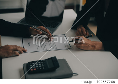 Businessman or job seeker review his resume on his desk before send to finding a new job with pen, necktie, glasses and digital tablet. 109357260