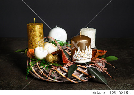 Decorative wreaths of four Advent candles in an Advent wreath decoration on a dark background. tradition before Christmas. Festive still life. 109358103