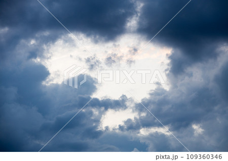Hole in clouds - stormy weather background Hole in clouds - stormy weather background 109360346