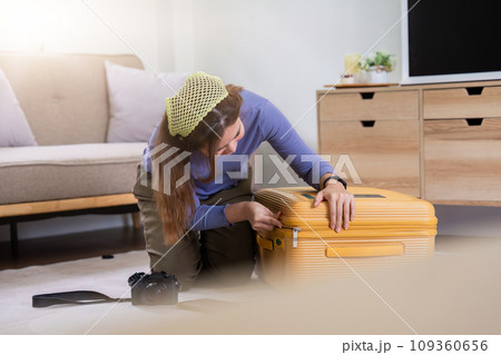 Woman packing a suitcase for a new travel trip. bag and luggage for journey 109360656