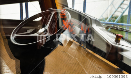 The cab of the world's largest dump truck. Steering wheel, dashboard and other controls. Payload 450 tonnes. View through the glass. 109361398