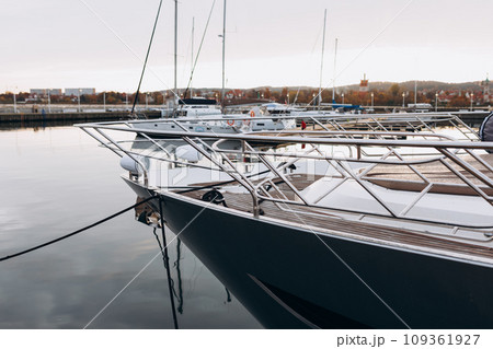 Luxury yacht anchored in the port. Ocean Coast pier. High class lifestyle. Sea transport. Journey concept. Yachting sport. Expensive yachts at the pier. 109361927